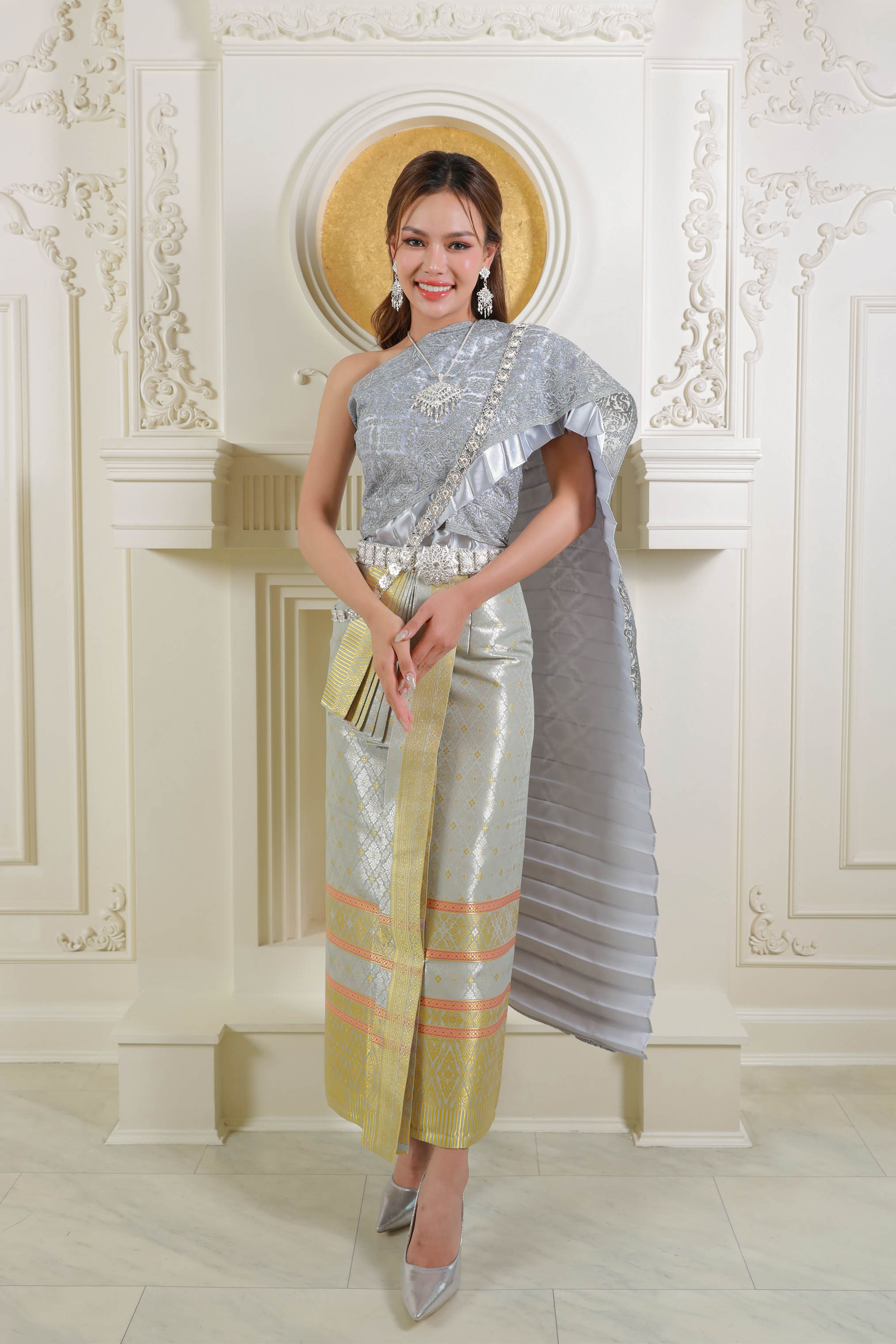 A woman in a beautiful Thai traditional dress, showcasing lace patterns and intricate details