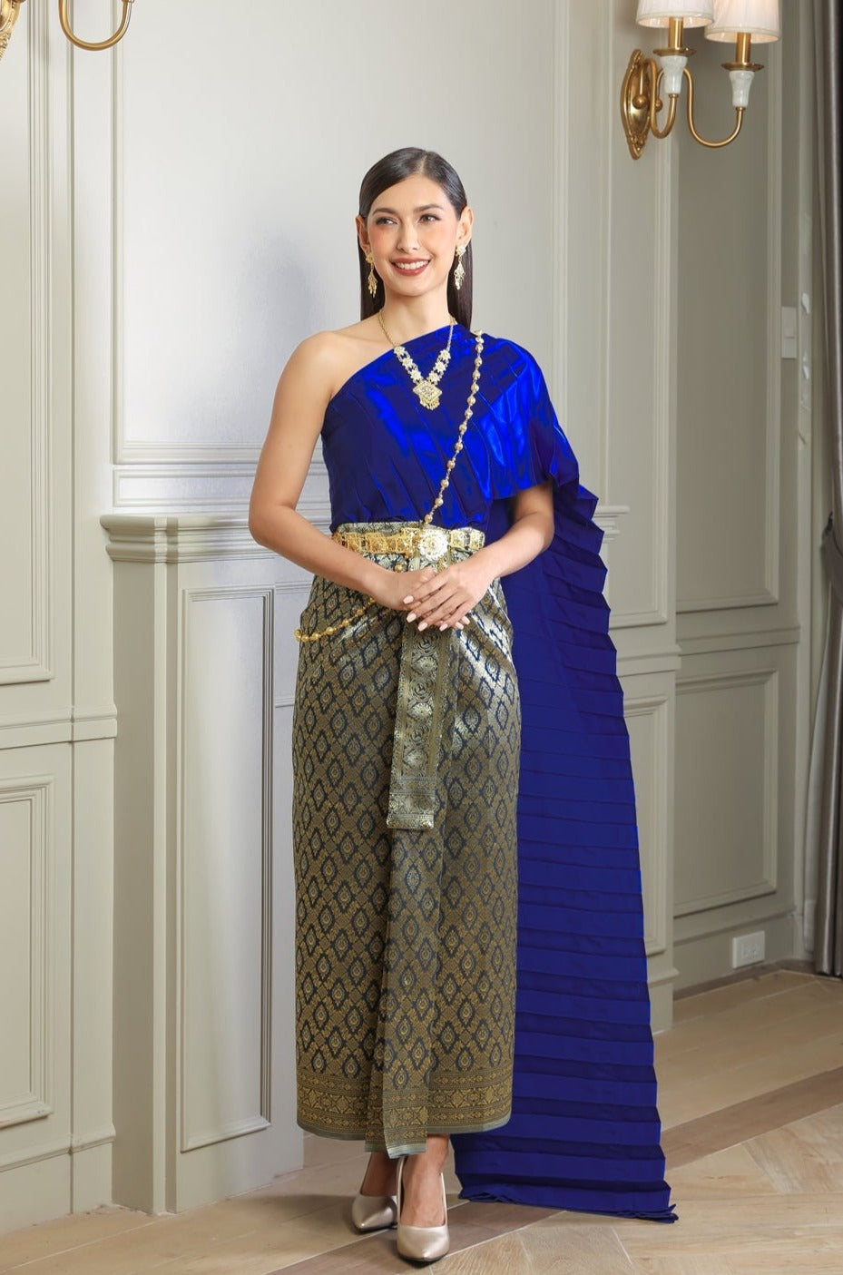 A woman wearing our royal blue traditional Thai dress.