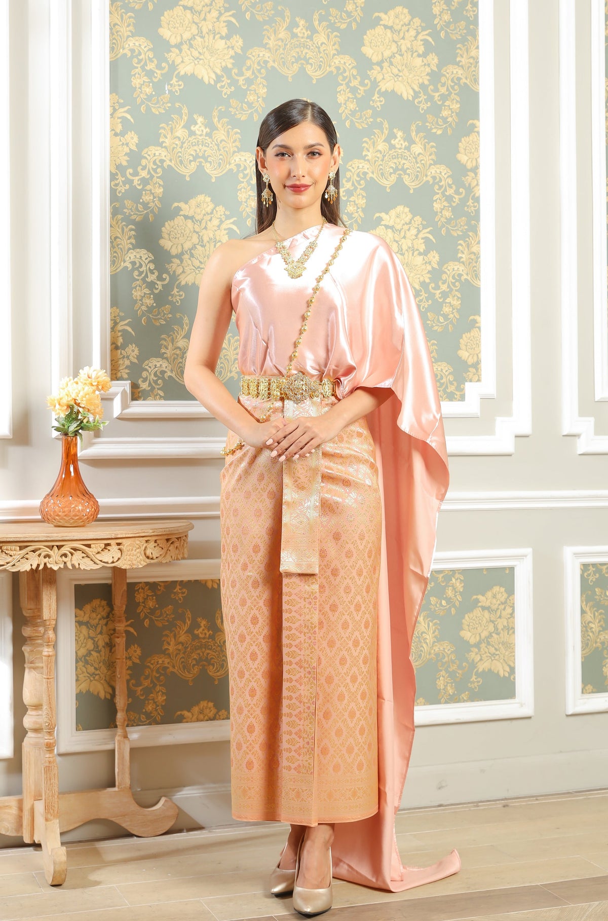 A rose gold traditional Thai outfit for women.